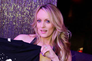 FILE PHOTO: Adult-film actress Clifford, also known as Stormy Daniels, poses for pictures at the end of her striptease show in Gossip Gentleman club in Long Island, New York