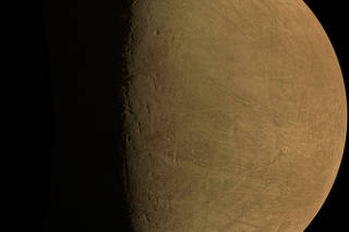 A raw image of JupiterÕs moon Europa captured by the JunoCam. (NASA/SWRI/MSSS via The New York Times)