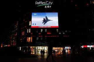 A giant screen broadcasting news footage of PLA taking part in an exercises around Taiwan, at a shopping in Beijing