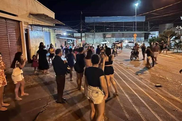 imagem à noite de pessoas na rua após tiroteio em igreja