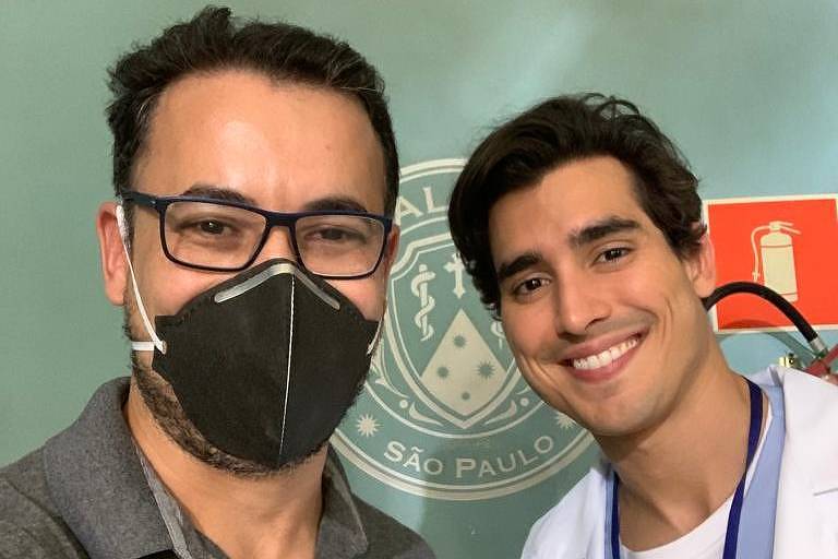 Médico Gerson Salvador usa máscara preta e ator Henrique Zaga está caracterizado como o personagem Gabriel no set de filmagem do filme "Depois do Universo"