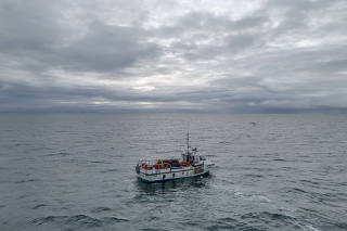 The Dignity Jay, owned by Alastair Mackie, fishes for crab and lobster in the seas off the coast of Isle of Mull, Scotland, March 5, 2023.  (Andrew Testa/The New York Times)
