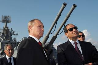 FILE PHOTO: Russia's President Putin, his Egyptian counterpart Sisi and Russia's Defence Minister Shoigu attend a welcoming ceremony onboard guided missile cruiser Moskva in Sochi