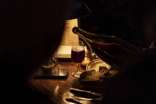 A glass of wine is poured at a bar in New York, Nov. 18, 2022. (Karsten Moran/The New York Times)