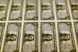 FILE PHOTO: File photo of United States one dollar bills seen on a light table at the Bureau of Engraving and Printing in Washington
