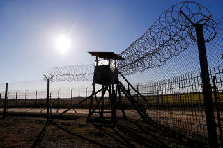 FILE PHOTO: A razor wire fence stands on the Hungarian-Serbian border next to the village of Roszke