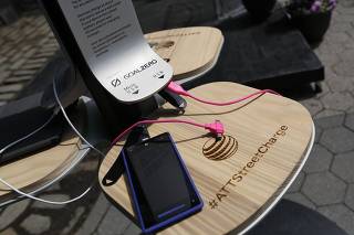A phone is being charged at a Street Charge station in the Brooklyn Borough of New York