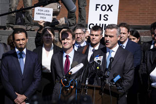 John Poulo, chief executive of Dominion Voting Systems, speaks at a news conference surrounded by his legal team following a settlement in their defamation lawsuit against Fox News at the Delaware Superior Court in Wilmington, Del., April 18, 2023. (Pete Marovich/The New York Times)