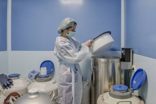 An embryologist at the IVMED fertility clinic in Kyiv, Ukraine on March 21, 2023. (Laetitia Vancon/The New York Times)