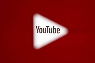 FILE PHOTO: A 3D-printed YouTube icon is seen in front of a displayed YouTube logo in this illustration
