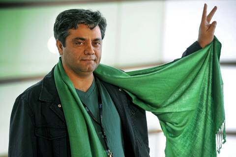 (FILES) In this file photo taken on September 19, 2009, Iranian director Mohammad Rasoulof shows his green scarf during a photo-call after the screening of his film 