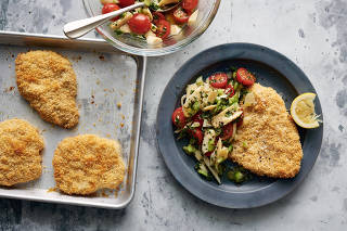Sheet-Pan Crispy Pork Schnitzel. Breaded and fried cutlets cut across a broad swath of cuisines; this iteration is baked in the oven for greater efficiency and less mess. Food Stylist: Simon Andrews. (David Malosh/The New York Times)