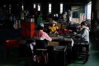Staff work on screw production at Chyuan Lian metal industrial company in Chiayi,