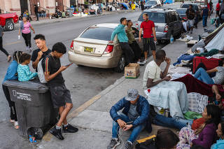 Migrants from several countries camped outside Sacred Heart Church, where they receive donated food and clothing, in El Paso, Texas, May 4, 2023. (Justin Hamel/The New York Times)