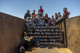 Venezuelan migrants on top of a freight train during their journey toward the U.S.-Mexico border in Ciudad Juárez, Mexico, on Monday, May 8, 2022. (Alejandro Cegarra/The New York Times)