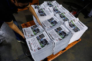 Employees work at the facilities of elPeriodico newspaper, in Guatemala City