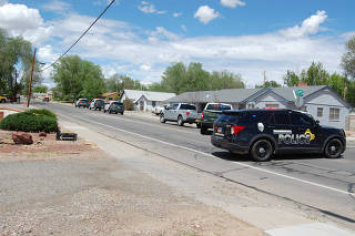 Law enforcement officers deploy at the scene of a fatal shooting in Farmington
