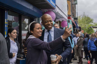 Mayor Eric Adams smiles for a photo while at the opening of a new small business in the Forest Hills neighborhood of Queens, May 4, 2023. (Hiroko Masuike/The New York Times)