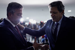 Brazil's Finance Minister Fernando Haddad greets Brazil's Lower House Speaker Arthur Lira during a news conference after a meeting on a government submission of a fiscal framework bill to the Congress in Brasilia