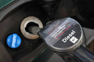 FILE PHOTO: A diesel fuel nozzle is pictured during refuelling of a car, at a filling station, after Russia's invasion of Ukraine, in Bad Honnef near Bonn