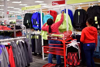 FILE PHOTO: An employee hangs children's clothing at a Target store in King of Prussia
