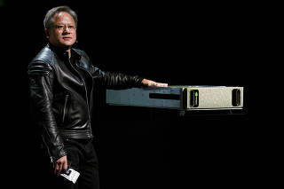 FILE PHOTO: Jensen Huang, CEO of Nvidia, shows his company's DGX AI supercomputer at his keynote address at CES in Las Vegas
