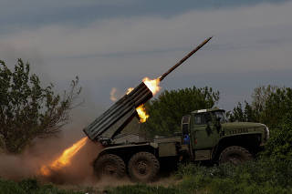 Ukrainian servicemen fire a BM-21 Grad multiple launch rocket system towards Russian troops near the frontline town of Bakhmut