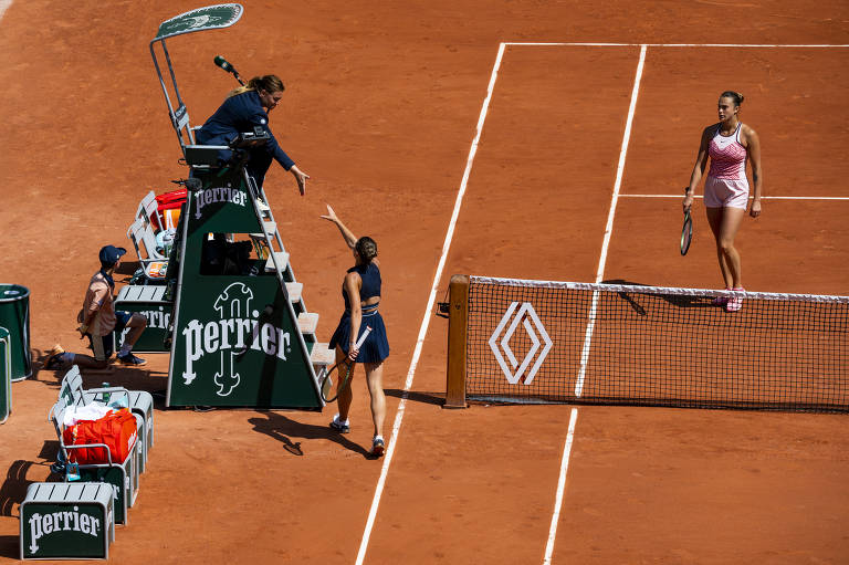 Tennis player Marta Kostyuk of Ukraine goes straight to the chair umpire, Louise Azemar Engzell, without shaking hands with her opponent, who won the match, Aryna Sabalenka of Belarus, right, at the French Open in Paris., on May 28, 2023. Kostyuk had the crowd on her side initially, but then was booed after she did not shake hands with Sabalenka after losing to her in straight sets. (Pete Kiehart/The New York Times)