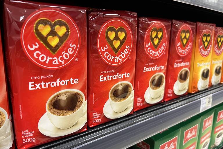 Pacotes vermelhos de cafés extraforte em prateleiras de supermercado