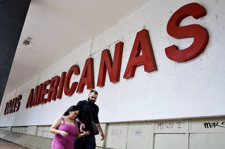FILE PHOTO: People walk in front of a Lojas Americanas store in Brasilia