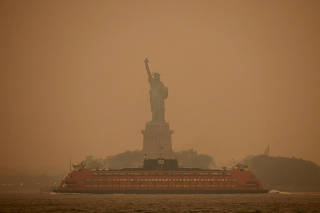 FILE PHOTO: The Statue of Liberty is covered in haze and smoke caused by wildfires in Canada, in New York