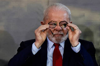 Brazil?s President Luiz Inacio Lula da Silva holds his glasses during an event for the World Environment Day in Brasilia
