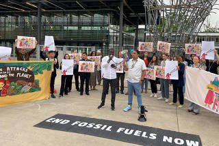 Activists hold an anti-fossil fuel protest at the pre-cop28 climate conference