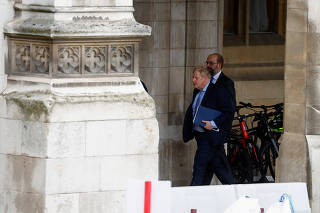 FILE PHOTO: Former British PM Johnson walks at the parliament in London