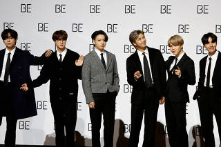 FILE PHOTO: Members of K-pop boy band BTS pose for photographs during a news conference promoting their new album 