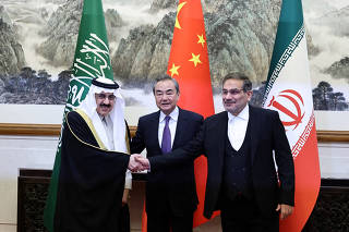 FILE PHOTO: China's director of the Office of the Central Foreign Affairs Commission Wang Yi, Ali Shamkhani, the secretary of Iran?s Supreme National Security Council and Saudi national security adviser  Musaad bin Mohammed Al Aiban meet in Beijing