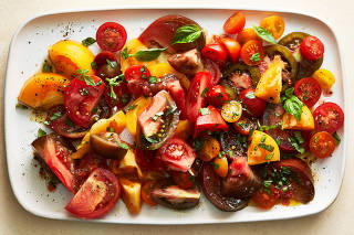 Sesame tomato salad in New York, May 8, 2023. Food styled by Cyd Raftus McDowell. (Armando Rafael/The New York Times)