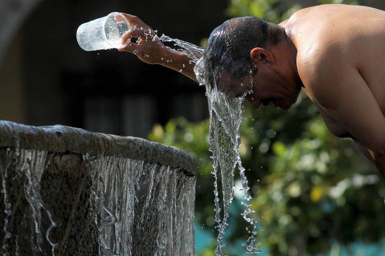 Homem se refresca em um dia de calor extremo em Guadalajara, no México