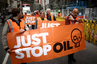 FILE PHOTO: Activists from Just Stop Oil take part in a slow march along a road in the City of London financial district