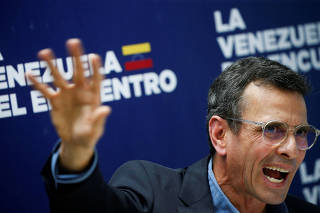 Venezuelan opposition leader Henrique Capriles addresses the media during a news conference, in Caracas