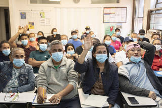 A class of recently arrived asylum seekers in Jackson Heights, Queens, study to obtain safety certification cards to become construction workers, June 14, 2023. (Kirsten Luce/The New York Times)