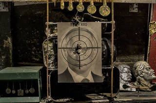 A portrait of Russian President Vladimir Putin serves as a target in a shooting gallery at Kryivka,a themed restaurant that evokes Ukraine?s armed fight for independence against Soviet Russia and Nazi Germany during World War II, in central Lviv, Ukrain
