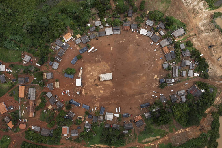 Vista aérea de casas da aldeia, dispostas em círculo, com um pátio no meio