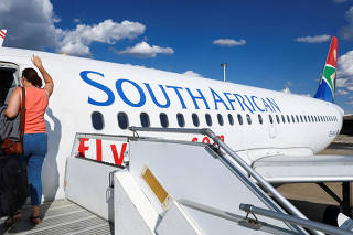 Passenger boards a South African Airways plane in Windhoek