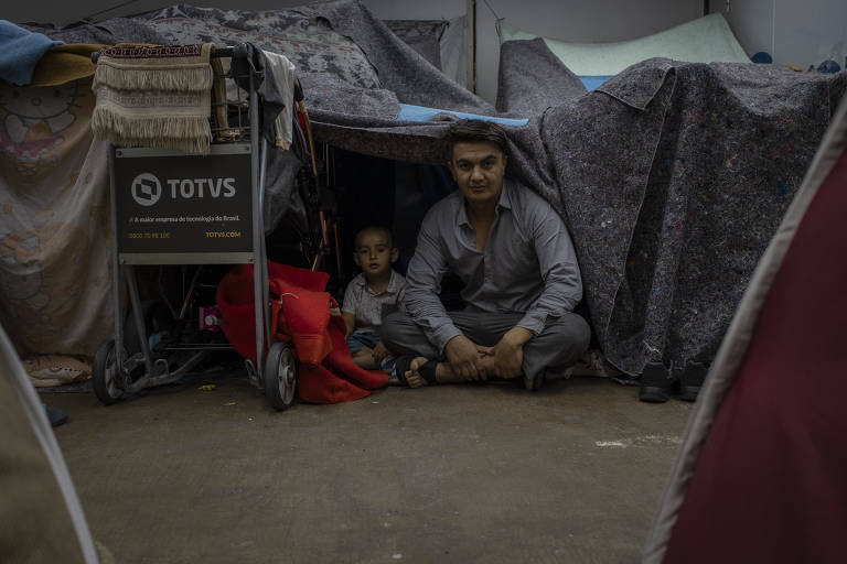 Hashmat Ullah Ahmadi, 33, e seu filho Danyal Ahmadi, 3, na tenda improvisada onde estão morando