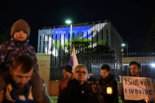 A Ukrainian flag is projected on the Russian Embassy in Washington during a protest on Feb. 24, 2023. (Kenny Holston/The New York Times)