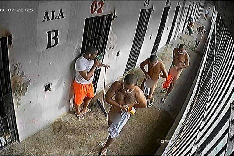 Presos caminham nus em fila diante de celas