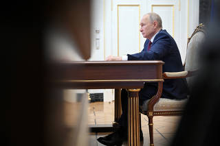 Russian President Putin chairs a meeting with members of the government, via video link in Moscow