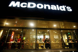 FILE PHOTO: Customers eat dinner at a McDonald's store in Beijing