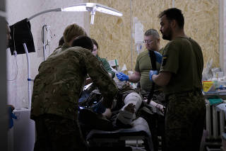 A still image from an undated video shows an injured Ukrainian soldier being treated at a military field hospital. (Yousur Al-Hlou/The New York Times)